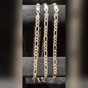 Three silver chains on black display stand.