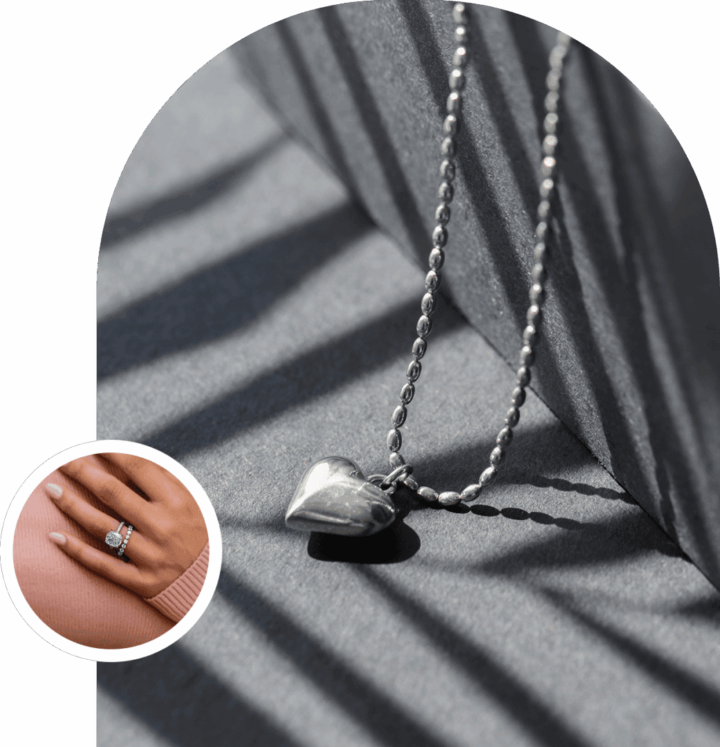 Heart pendant necklace with ring on hand.